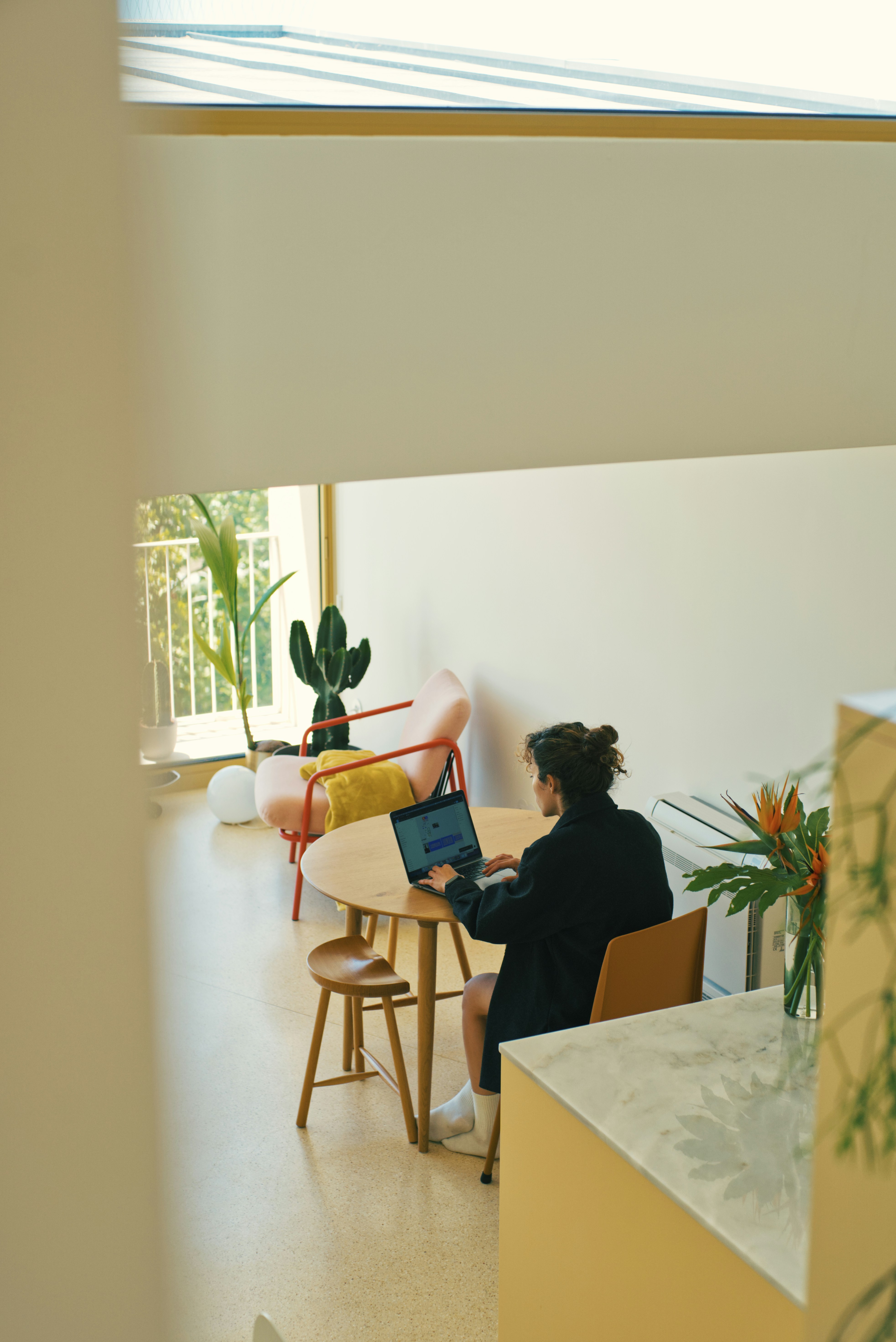Bright coworking space with someone working at a table